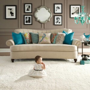 Cute baby sitting on carpet floor | CarpetsPlus Of Wisconsin