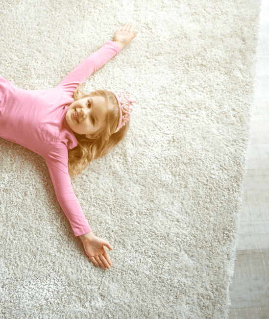 Cute girl laying on rug | CarpetsPlus Of Wisconsin